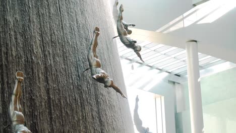 diving figures on a water wall