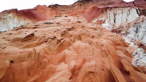 aerial flying over red sand hill next to fairy stream, mui ne, vietnam