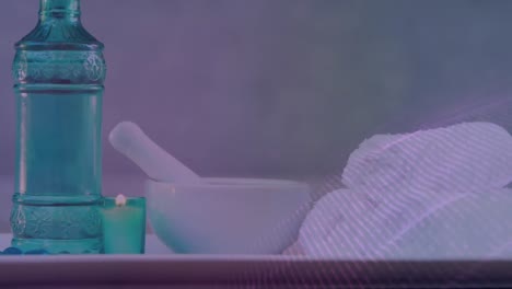 animación de brillo sobre botella, cuenco y toallas