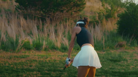 slow-motion clip of an amateur female golfer hitting a driver off the tee. captured outdoors on a sunny golf course, showcasing an approachable swing and beginner technique