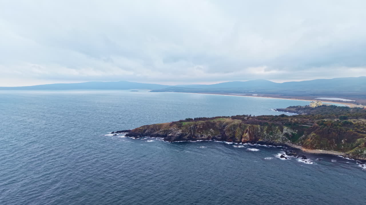 Breathtaking coastal view capturing the meeting of sky and sea at a tranquil shoreline during an overcast day