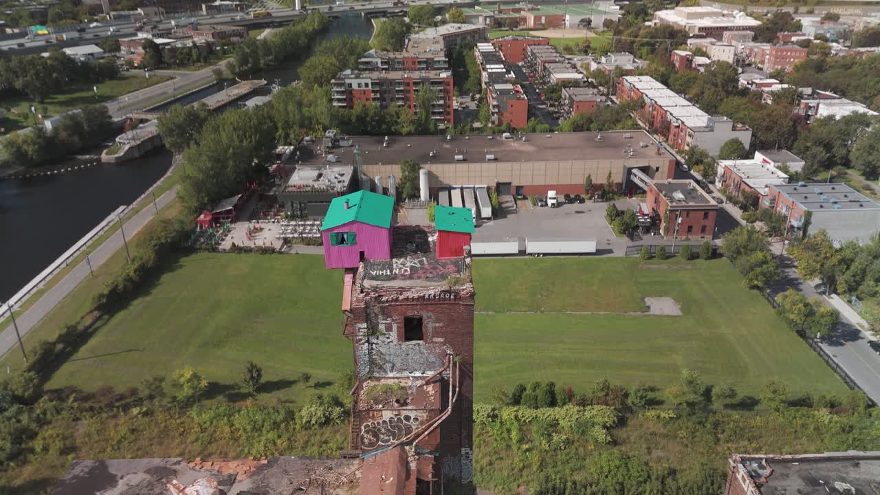 A reveal shot by drone of the famous little pink house in Montreal.