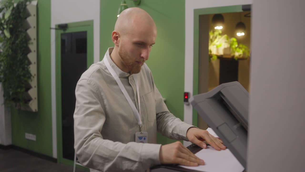 Man using a photocopier in an office