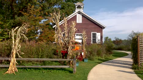 autumn-decorations-of-pumpkins-and-corn-outside-a-historic-old-schoolhouse-4k