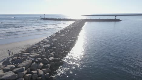 aerial view of oceanside north jetty at sunset