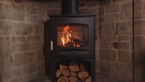 slow motion lit stove burning in stone fireplace