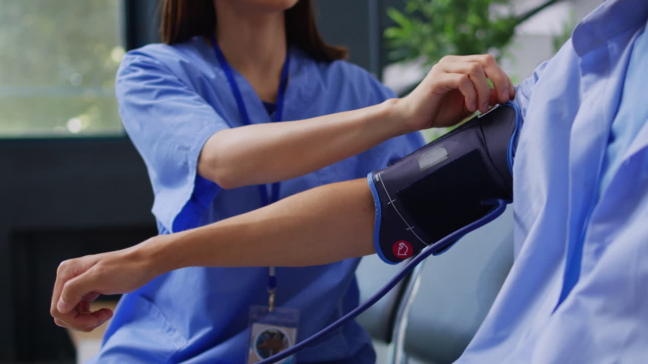 Nurse checking patient's blood pressure