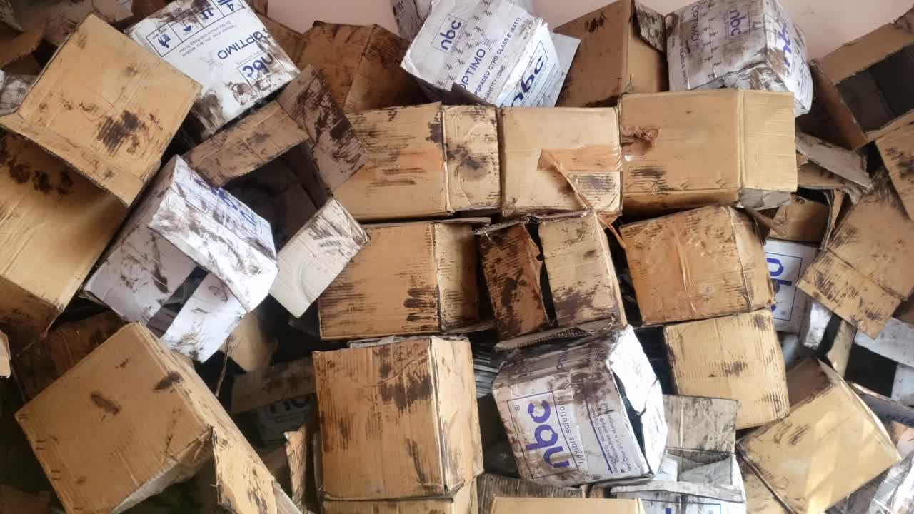A Stack of Train Wheelset Bearing Packaging Boxes. The background is filled with more stacks of similar boxes and industrial shelving units