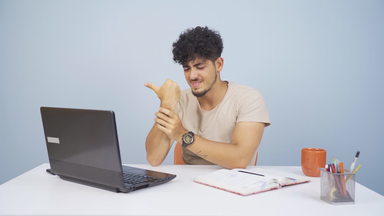 la muñeca del hombre que usa una computadora portátil duele.