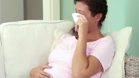 Pregnant-woman-crying-on-the-couch