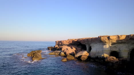 aerial shot of beautiful sea caves at the coast of a holiday resort