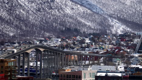 city waterfront, winter snow, urban hillside, bridge crossings tromso