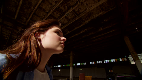 young woman in an abandoned factory