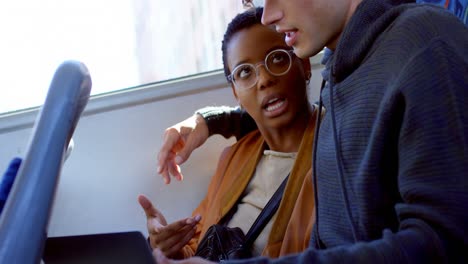 Couple-discussing-over-a-laptop-while-travelling-in-bus-4k