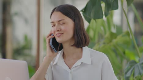 businesswoman speaking on phone in outdoor cafe