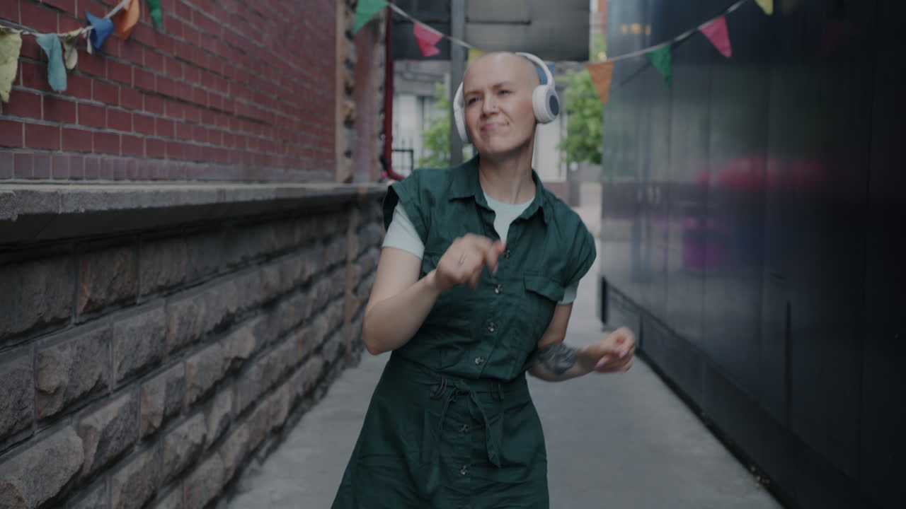 Woman Dancing in an Urban Alleyway with Headphones