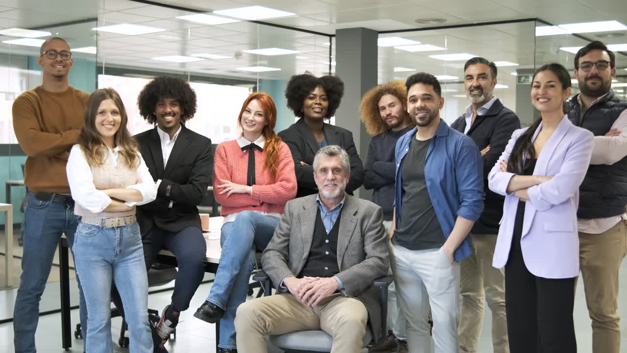 Group of cheerful multiethnic businesspeople standing in office