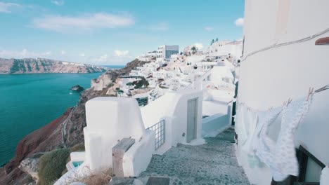 freshly washed clothes on a street of oia, santorini