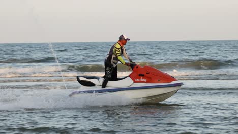 person performing stunts on a jet ski in the ocean