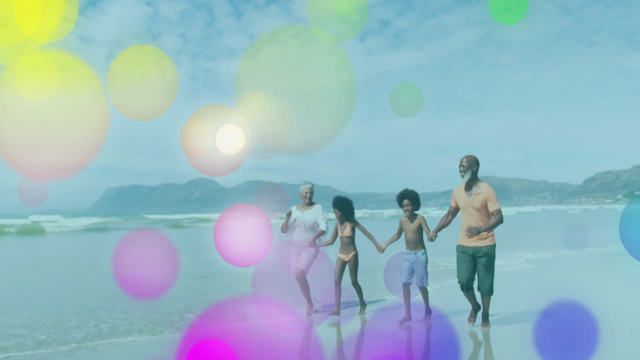 family walking on wet shoreline, health campaign using colorful bokeh circles data overlays