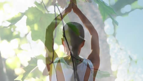 animation of leaves over caucasian woman practicing yoga and meditating