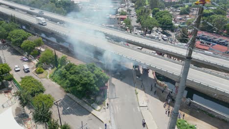 aerial clip car on fire under bridge