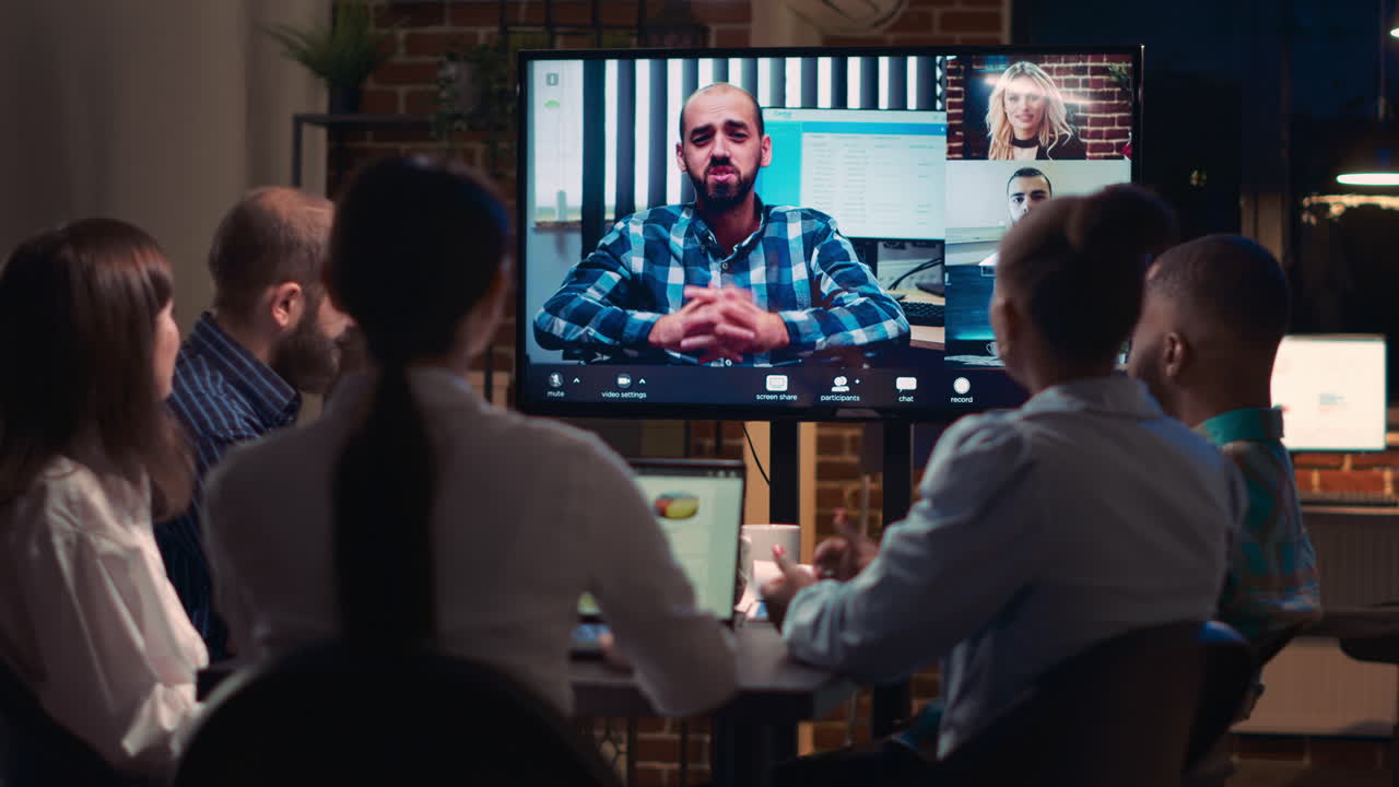 Employees discussing presentation with remote team in videocall app