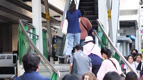 people climbing stairs at a crowded train station