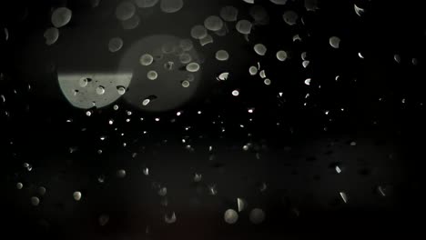 raindrops at night creative footage black background. rainy weather. take one.