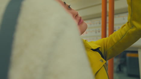 close up of young woman standing on underground train on journey to work or visiting city 1