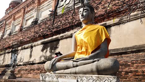 buddha statue with yellow robe in ayutthaya