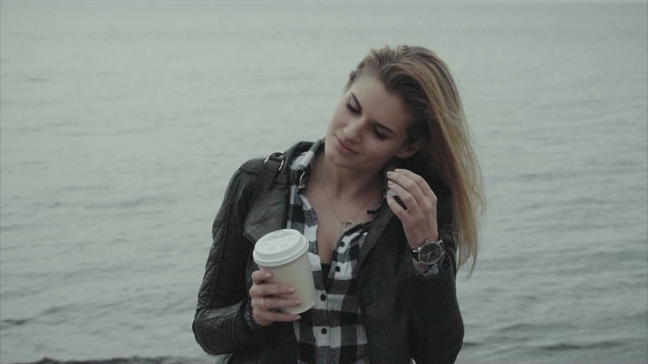 Woman with Coffee by the Sea