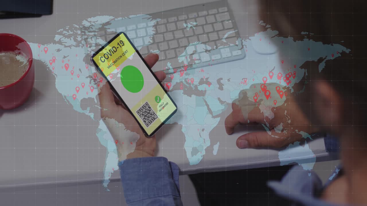 Animation of man holding smartphone with covid 19 vaccination passport over world map