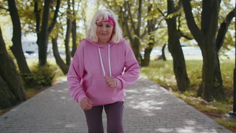 athletic fitness senior sport runner woman grandmother training workout cardio in park at morning