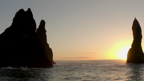 Slow-dolly-back-reveal-shot-of-Reynisdrangar-sea-stacks-Iceland