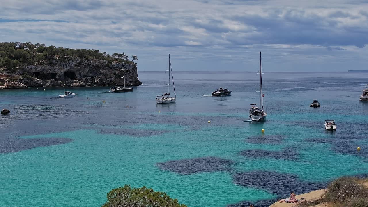 Sailboats anchored in clear waters off the coast of Mallorca Spain