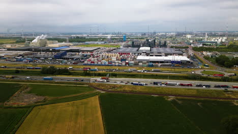 container depo with truck jam on highway road, aerial view