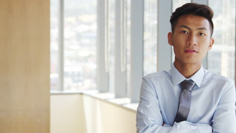 portrait of businessman in office walking towards camera
