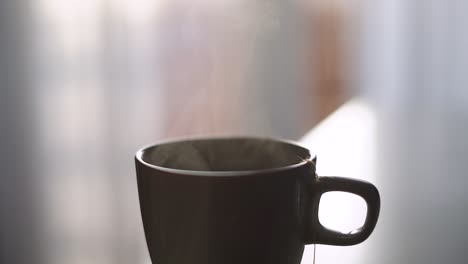 steaming cup of tea, brown mug, close up