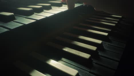 grand piano keyboard, camera moves forwards to the right, closeup, slow motion, dark, black