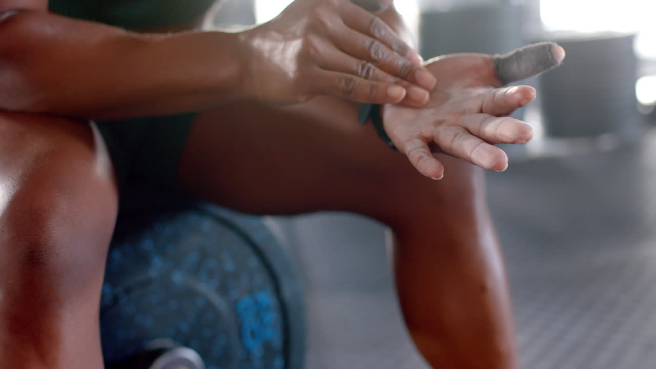Applying chalk on hands, woman preparing for weightlifting in gym, copy space