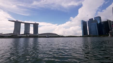 Panoramic-view-on-sunny-day-with-clouds,-silhouette-of-large-Marina-Bay-Sands-hotel