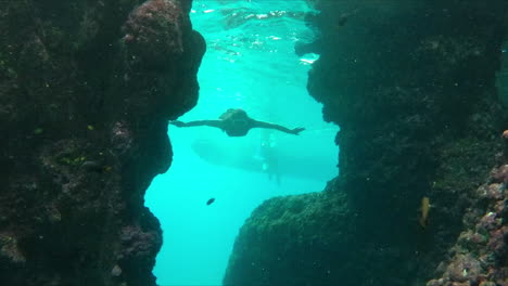 Woman-free-diving-and-exploring-underwater-marine-life
