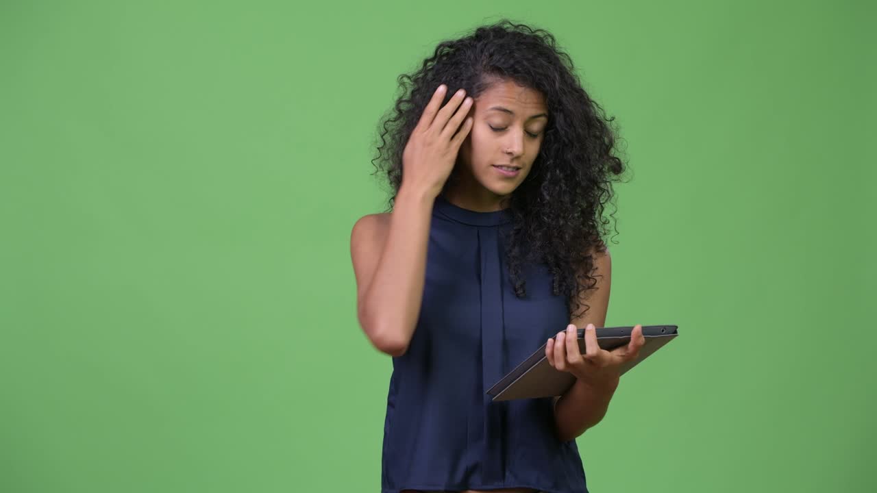 Young beautiful Hispanic businesswoman using digital tablet