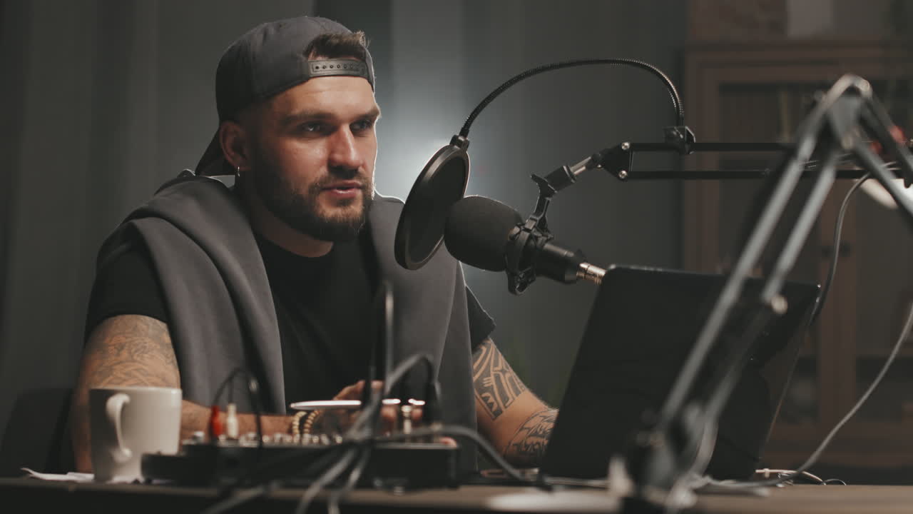 Tattooed Man with Beard Recording Podcast