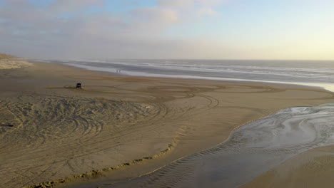 wild car driver driving in circles at the beach, then driving off into the distance