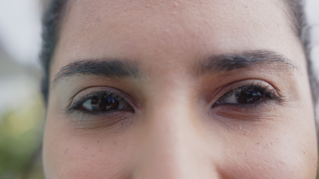 Close-up of mature asian woman with relaxed expression, focusing on eyes and skin