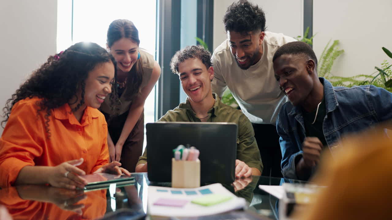 Diverse Group of Young Professionals Collaborating and Laughing in Modern Office