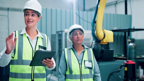 factory workers inspecting machinery with a robot