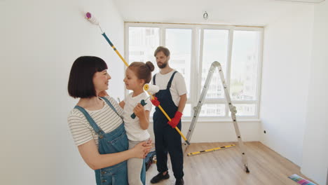 family painting a room together